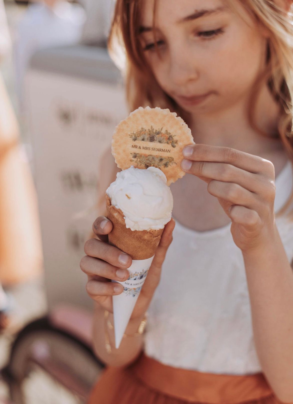 A young guest admiring her personalised wafer