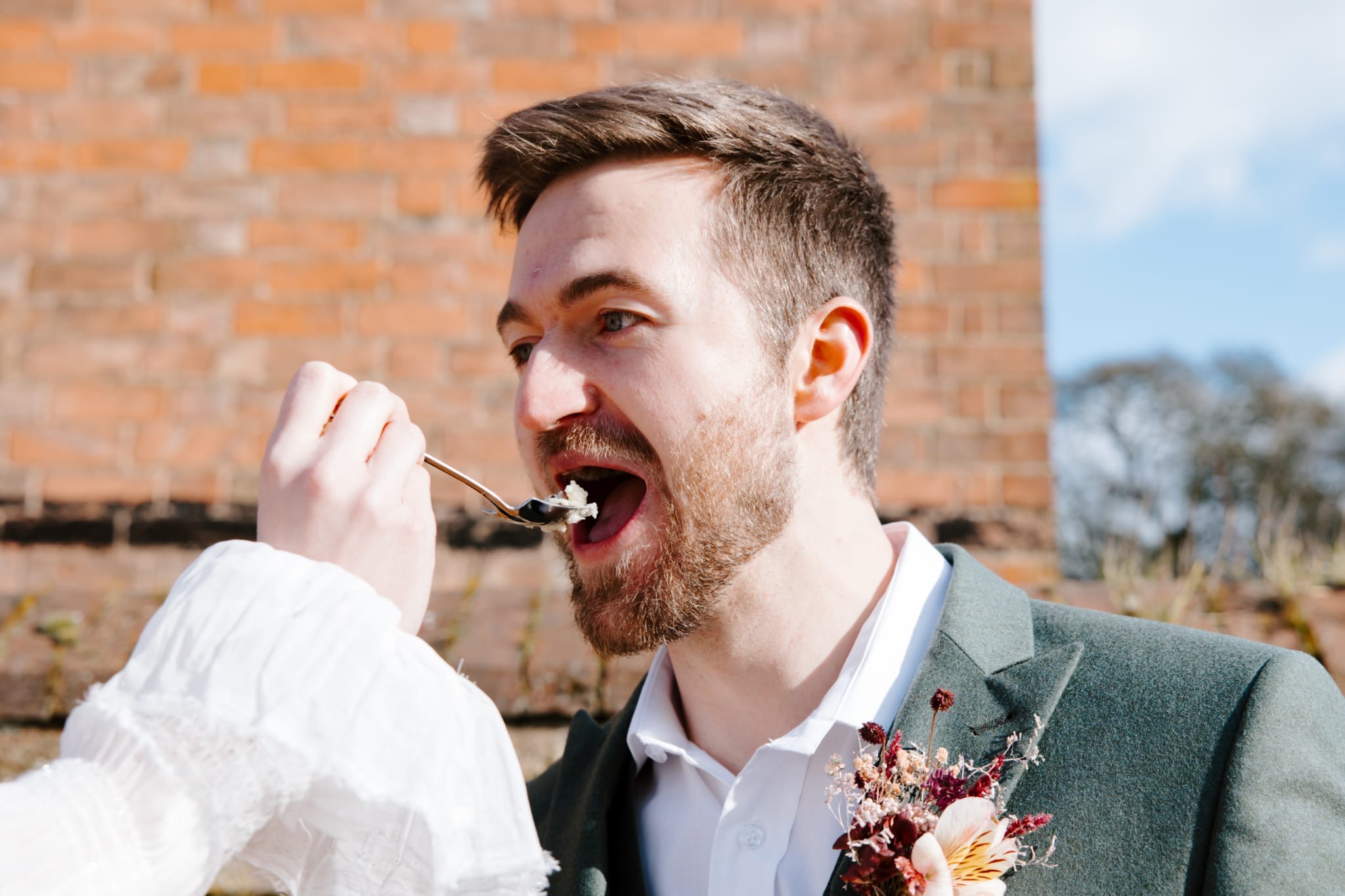 Bride feeding the groom a spoonful of ice cream
